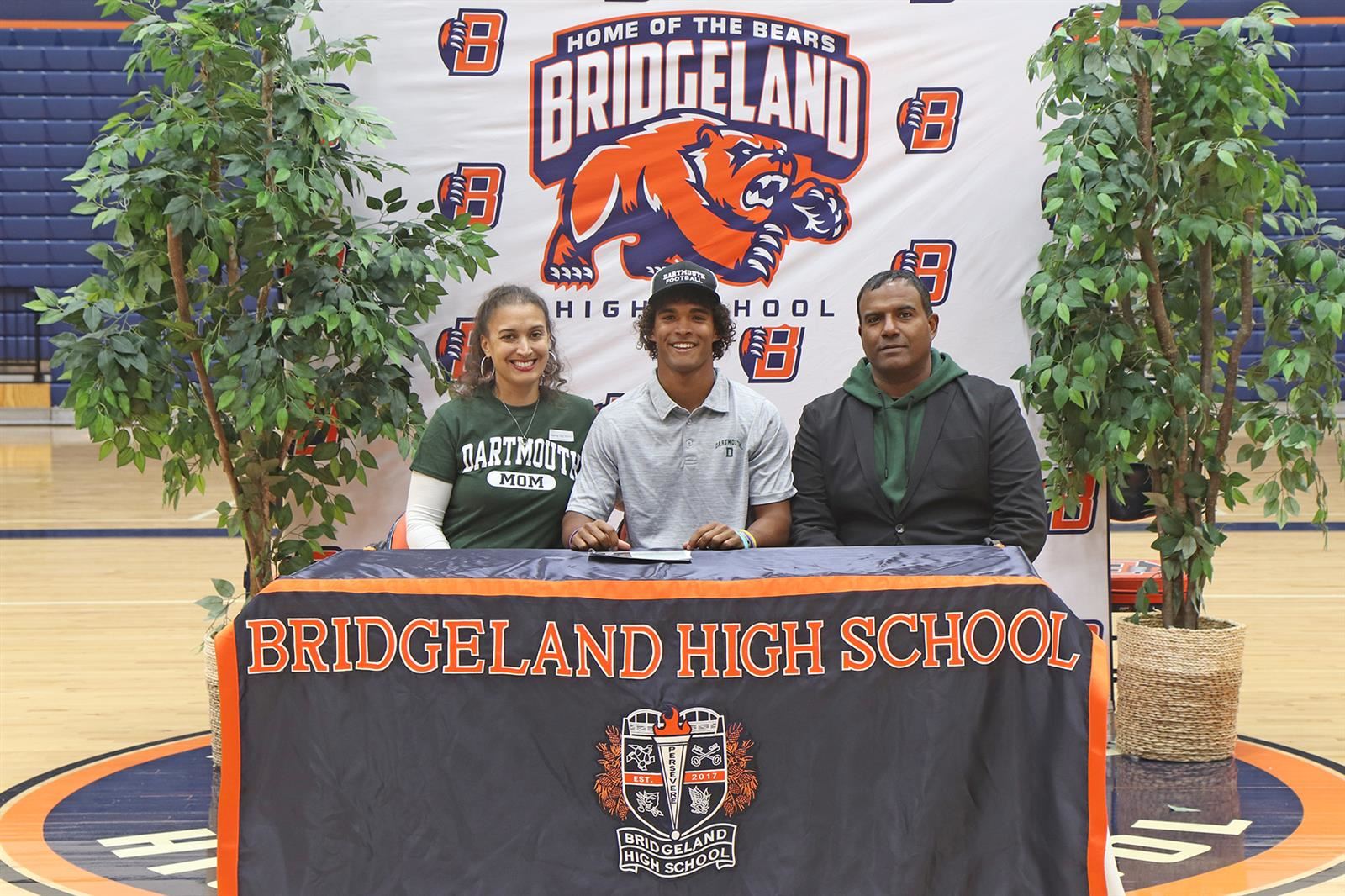 Bridgeland High School senior Jonathan Nelson, center, signed a letter of intent to play football at Dartmouth College.